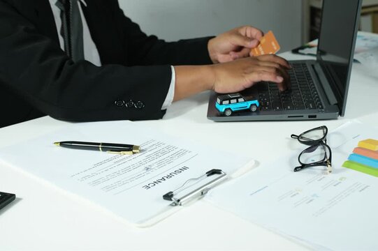 Digital banking concept, secure online payments, man holding credit card in front of laptop, online insurance, payment process, entering credit card security code on laptop, transportation insurance c