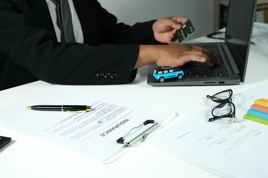 Digital banking concept, secure online payments, man holding credit card in front of laptop, online insurance, payment process, entering credit card security code on laptop, transportation insurance c
