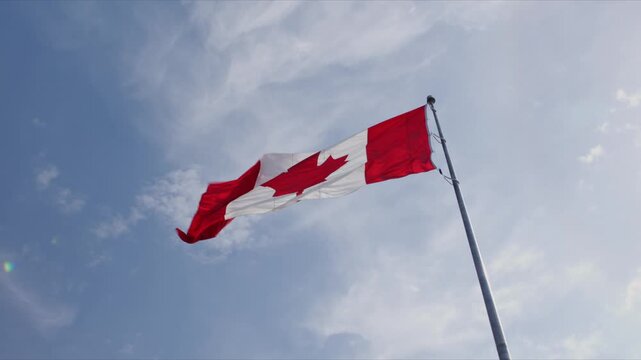 The Canadian flag flies high above downtown Halifax. The sky is blue as the flag flaps in the wind. This spot shows a symbol of Canada&rsquo;s pride in the city