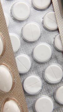 Rotation macro blister capsule pills, tablets, top view, close up texture background pharmaceutical industry concept