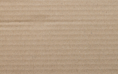 Fototapeta premium Brown Corrugated Cardboard Texture Background,Macro,Close-up full frame shot of a light brown corrugated cardboard sheet, highlighting the natural paper fiber texture and parallel embossed ridges.