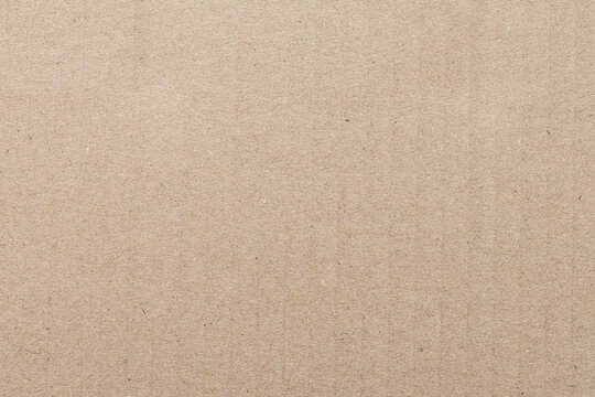 Brown Corrugated Cardboard Texture Background,Macro,Close-up full frame shot of a light brown corrugated cardboard sheet, highlighting the natural paper fiber texture and parallel embossed ridges.