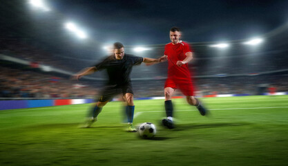 Soccer players battling for ball with motion blur in fast night game. Concept of football rivalry, sports speed, club competition, match broadcast and athletic gear promotion. © master1305