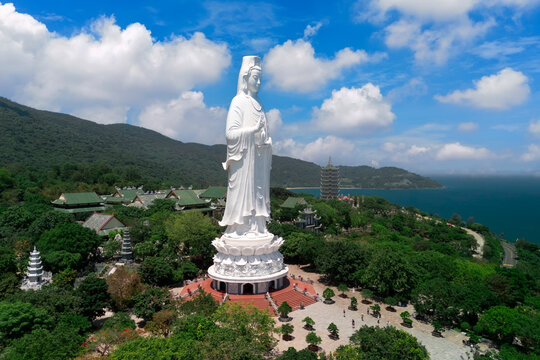 Majestic view of the Lady Buddha statue beside Linh Ung Pagoda, surrounded by lush hills and Da Nang s coastal beauty. Ideal for travel, culture, and spiritual stock photo collections.