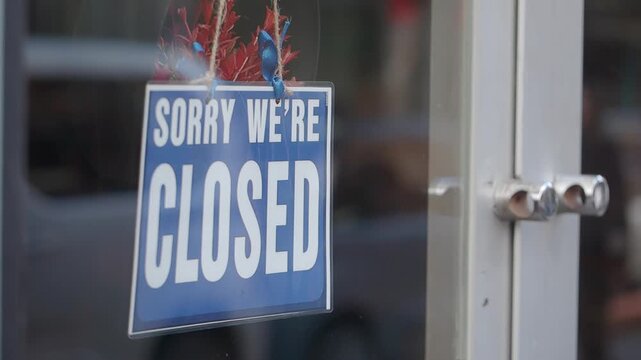 Shop displays closed sign during business hours