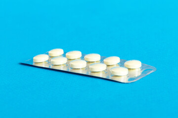 Blister package with Vitamin on color background. Medicine pills on a light background. Medicines...