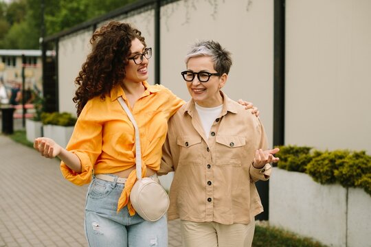 Two generations of women walking, sharing friendship