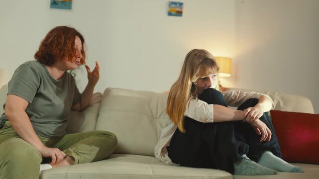 Mother arguing with her teenage daughter on the couch