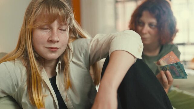 Distressed young woman crying over money problems at home