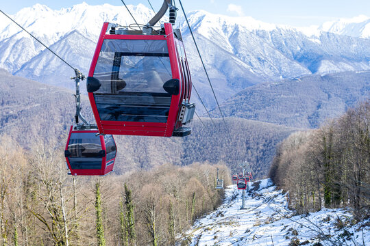 Gondola lift against the backdrop of snow-capped mountains
