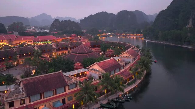 Aerial view of Tam Coc, a Historic Old Town Island in evening, Surrounded by Carst Mountains in Ninh Binh, Vietnam.