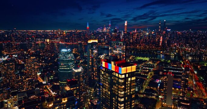 Descending over the scenery of vibrant metropolis with gorgeous illumination. Night panorama of New York City at night.