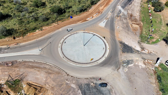 Aerial view of a newly constructed roundabout with a white pickup truck and surrounding construction site in Vaalwater, Limpopo, South Africa.