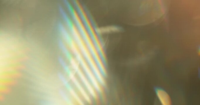 Slow motion of lens flare isolated on black background. Colored spectrum. Cinematic glowing light overlay with optical streaks and rays for VFX compositing and transitions.