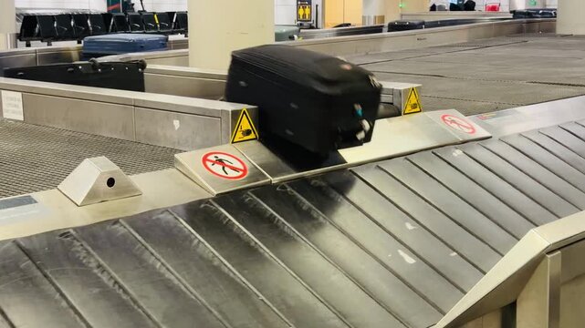 Luggage Claim Carousel with Suitcases in an Empty Airport Terminal