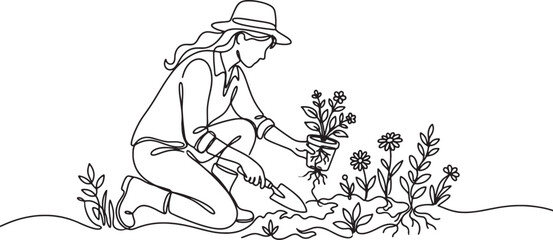 woman planting flowers in garden with shovel © Sumon90cs