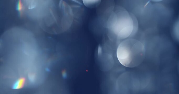 Slow motion of lens flare isolated on black background. Colored spectrum. Cinematic glowing light overlay with optical streaks and rays for VFX compositing and transitions.