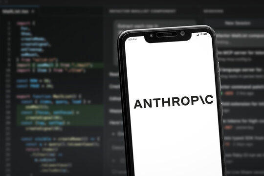Cali, Colombia - May 27 2026: Smartphone displaying Anthropic AI branding with programming interface background