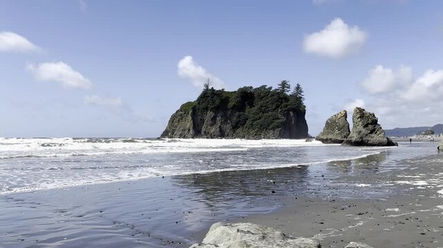 waves crashing on beach and rock stack on Ruby Beach in Olympic National Park 