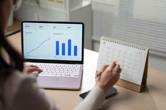 Businesswoman analyzing business data dashboard with calendar planning, operational indicators, strategic management, workflow organization, and corporate performance analysis.