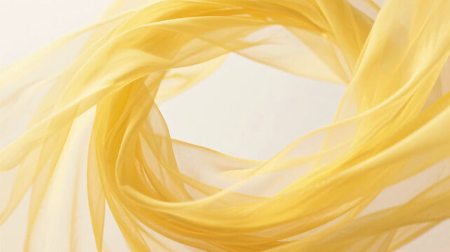 Yellow silk fabric swirling into a circular spiral shape, elegant background