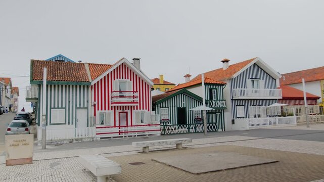 A slow panning shot showing the famous traditional colorful striped houses on the coast of Costa Nova in Portugal. 24.05.2026