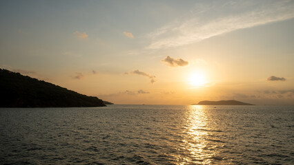 Obraz premium Golden sunlight reflects off the water, creating a peaceful atmosphere as the day ends over the tranquil Prince Islands and surrounding landscape.