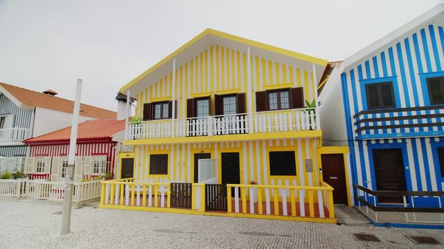 A slow panning shot showing the famous traditional colorful striped houses on the coast of Costa Nova in Portugal. 24.05.2026