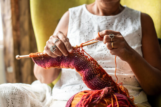 Woman knitting colorful yarn project