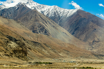 Fototapeta premium Tangtse, or Drangtse village in Ladakh's Leh district, located on the route to Pangong Lake, Leh via the high-altitude Chang La pass. Serving as a green oasis in the arid valley, Leh, Ladakh, India.