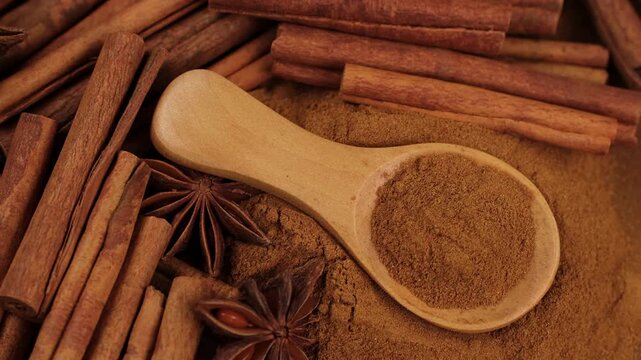 Cinnamon powder and cinnamon sticks close up, slider view