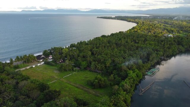 Drone aerial footage of Cantilan in Mindanao, Philippines featuring tropical coastline, river, ocean water, forest, lush jungle and natural island landscape.