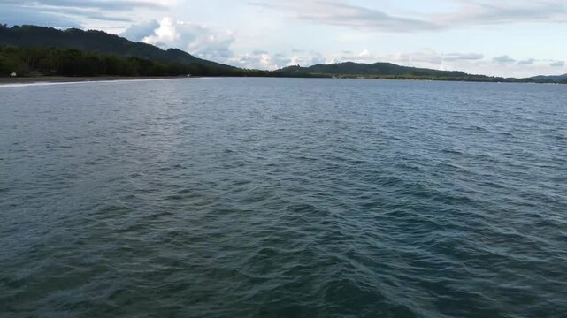 Drone aerial footage of Cantilan in Mindanao, Philippines featuring tropical coastline, river, ocean water, forest, lush jungle and natural island landscape.