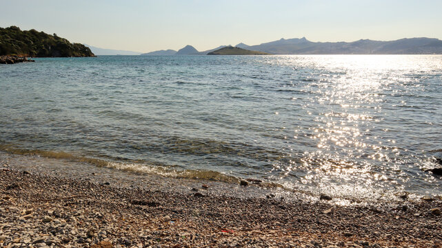 Bitez bay coastline overlooking the aegean sea with sparkling water reflecting afternoon sunlight near Bodrum, Turkey