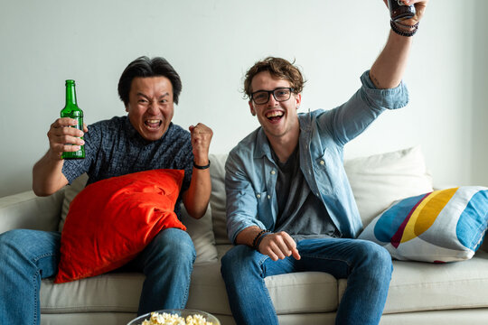 Friends cheering with drinks indoors