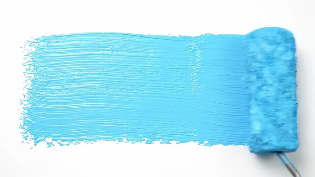 Close up of paint roller applying bright blue paint stroke on pure white background, concept of home renovation and interior design