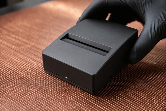 Hand Pressing Financial Validator into Copper Mesh