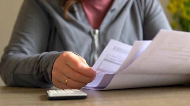 Using Desktop Calculator with Financial Invoices &mdash; Hand Pressing Keys for Business Bookkeeping, Accountant Data Entry and Tax Prep Audit
