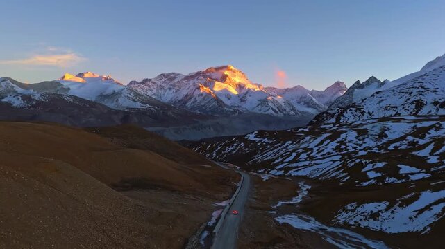 Sunrise over Snow Covered Himalayan Mountains and Winding Road in Himalayas