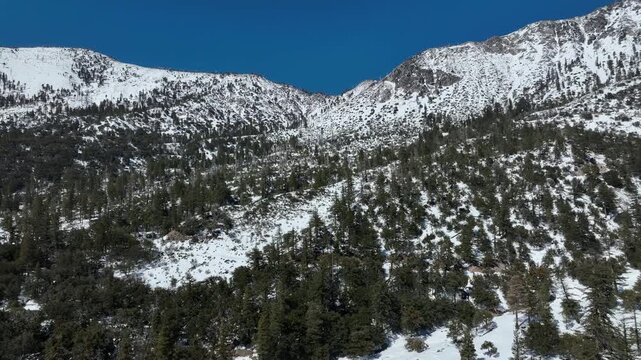 Epic Winter Scenery Aerial Views of Snow Covered Mountains Tilt Up Back in San Gabriel Mts California USA