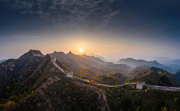 Golden sunrise over Jinshanling Great Wall, autumn foliage covering mountains in Chengde, Hebei, China, panoramic scenic landscape.