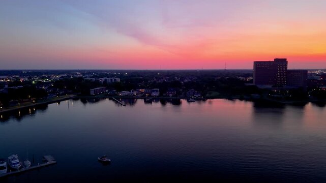 Portsmouth, Virginia, scenic 4K aerial video establishing the historic Olde Towne waterfront and residential district along the Elizabeth River during a quiet golden hour sunset.