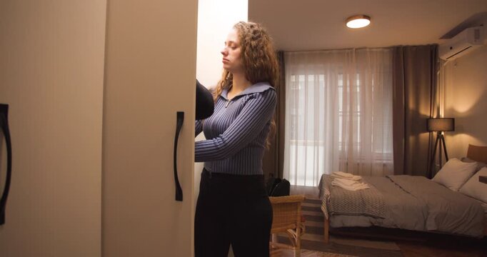 Young Woman Deciding What to Wear in Front of Her Closet