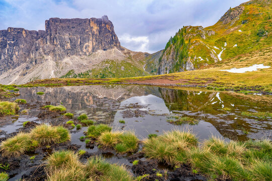 Mirror reflections of Ra Gusela pond in the Dolimte Alps, Italy