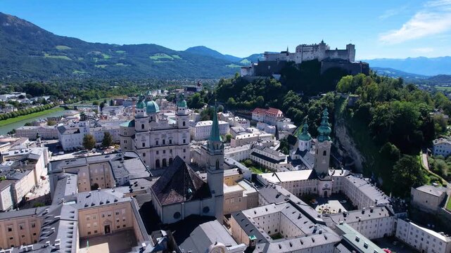 Salzburg Austria Aerial 4K. Drone cinematic old townscape of historic center with majestic Hohensalzburg Fortress and baroque churches. Scenic Salzach river valley landscape. Summer travel destination
