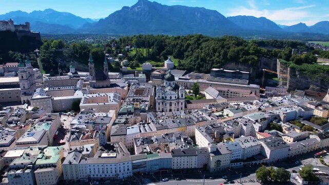 Salzburg old town aerial 4K drone footage historic center churches fortress Alps background flight from bridge cinematic overflight travel Austria tourism destination