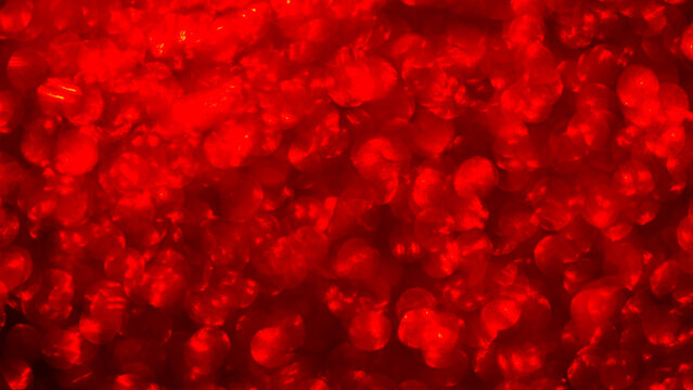 Bright red bubbles fill the frame with vivid color and texture, creating an interesting visual effect