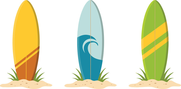 Collection of three colorful surfboards standing in sand on beach with green grass under clear sky for summer sports concepts.