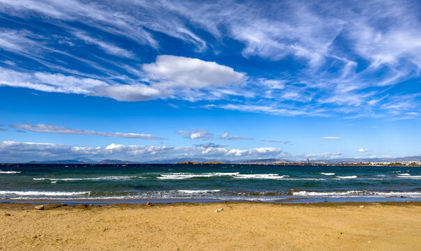 Sunny coastal view from Kavouri Beach toward the distant Ellinikon project in Attica Greece