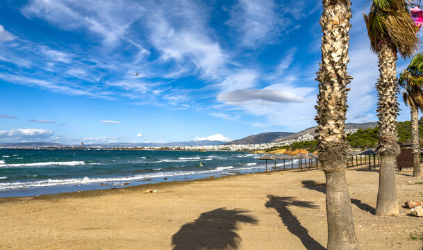 Sunny coastal view from Kavouri Beach toward the distant Ellinikon project in Attica Greece